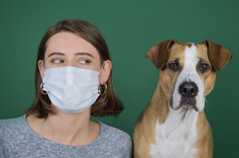 Woman and dog with face mask